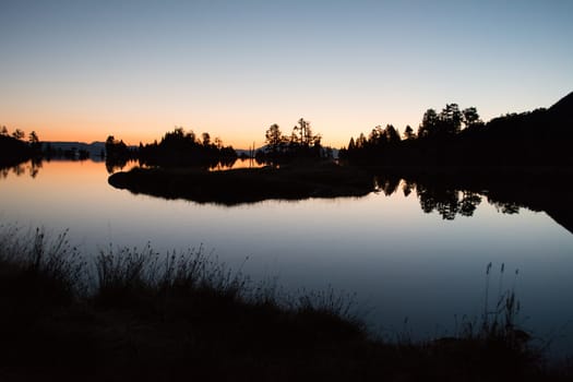 Sunrise lake in the Spanish Pyrenees, located at mountain hut JM Blanc, Aigüestortes i Estany de Sant Maurici national park