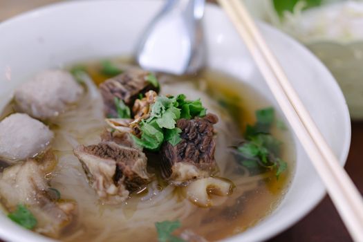 Rice noodle soup with Cooked Liver in  bowl on table, selective focus
