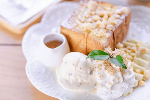 Honey toast dessert with ice coffee on wood table, top view