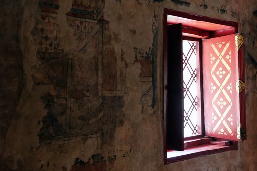 Detail image of ancient window and mural painting is located in Phumin temple, Phumin temple is a famous temple in Nan province, Thailand