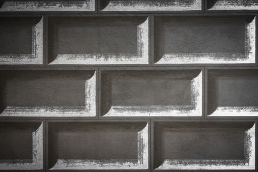 Faux bricks painted on a wall, with white silhouettes.