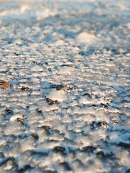 Road covered with ice in the headlights