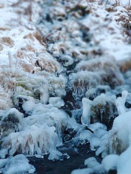 Mountains frozen with ice in winter. Earth, stones are covered with ice.