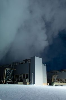 Night view. Thermal power plant building at a hot spring. Icelandic industry.