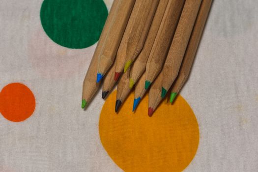 colored crayons lined up on a colored plane, horizontal image