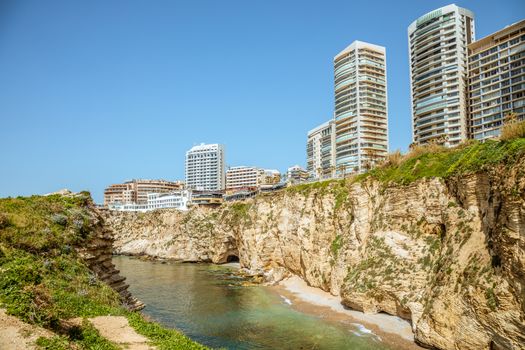 Downtown buildings and towers with rocks and sea in the foreground, Beirut, Lebanon