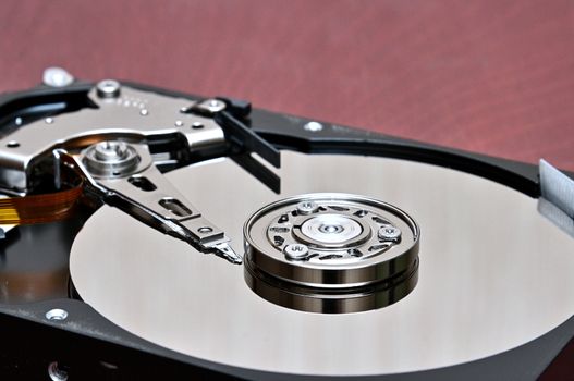 Internal parts of a hard disk on an isolated braun,wood background.