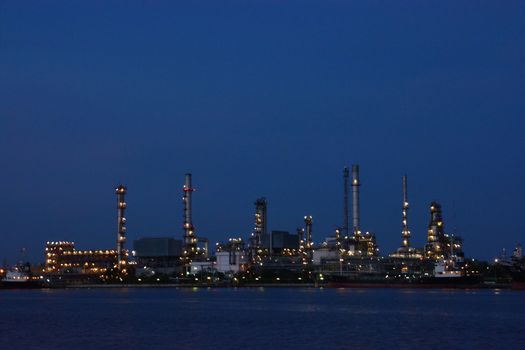Oil Refinery factory in the evening , petrochemical plant , Petroleum.