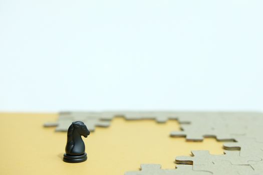 Business strategy conceptual photo - horse knight standing in front of jigsaw piece puzzle