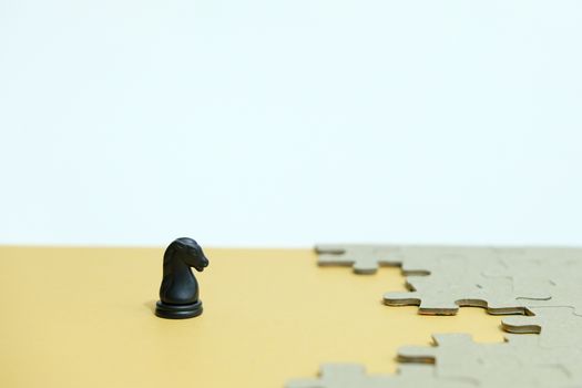 Business strategy conceptual photo - horse knight standing in front of jigsaw piece puzzle