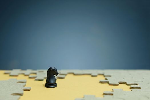 Business strategy conceptual photo - horse knight standing in front of jigsaw piece puzzle