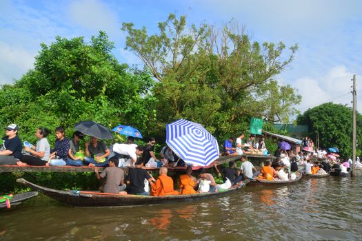 BANGKOK, THAILAND – OCTOBER 8, 2017 : Tuk baat Phra Roi River Festival (Give alms to a Buddhist monk on boat) On the Lamplatiew Canal in front of Wat Sutthaphot, Lat Krabang District Bangkok