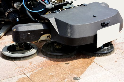 urban sweeper cleans road from dirt with a round brush