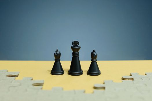 Business strategy conceptual photo - chess troops standing in front of jigsaw piece puzzle