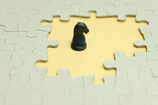 Business strategy conceptual photo - horse knight standing in front of jigsaw piece puzzle