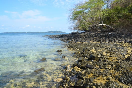 Koh Hin Ngam  is a unique small island unlike other island. It's covered with small black rocks in Tarutao Marine National Park in Satun Province, Thailand