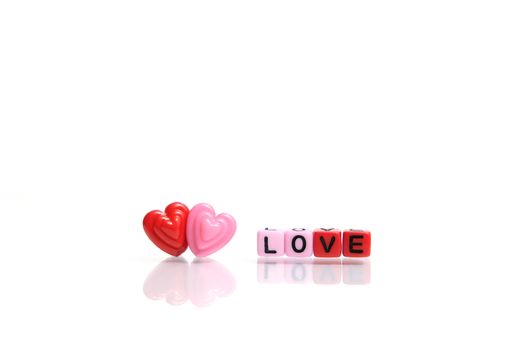Red and pink heart shape with LOVE word beads. Romance concept