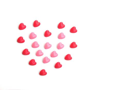 Red and pink heart beads shape, top view flat lay with white background. Love and romance conceptual object