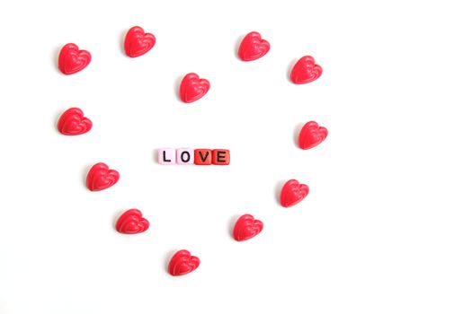 Red and pink heart beads shape, top view flat lay with white background. Love and romance conceptual object