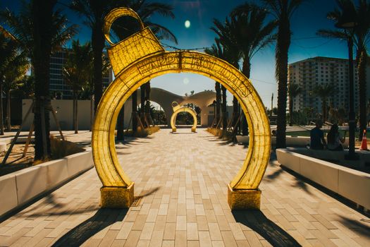 A Yellow Holiday Arch Fashioned to Look Like a Christmas Ornament at Sunset