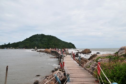 CHANTABURI, THAILAND – 4 AUGUST 2019 : Chedi Ban Hua Laem  There is a wooden bridge that goes out into the sea to see the Chedi that situated in the middle of the water.