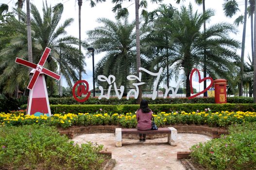 PHICHIT, THAILAND – 1 OCTOBER 2019 : Tourists sit on chairs that are arranged to be photographed spots at label character of at Bueng Si Fai public park