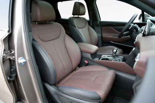 Front seats upholstered in red leather in a large modern SUV