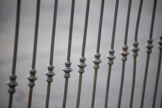 symmetrical detail of an iron railing placed on a balcony