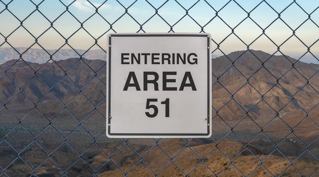 Entering Area 51 Sign On A Fence At The Military Base In The Nevada Desert At Sunset