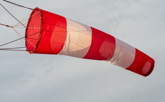 red-and-white wind designator designed to indicate the direction and approximate speed of the wind on the seashore