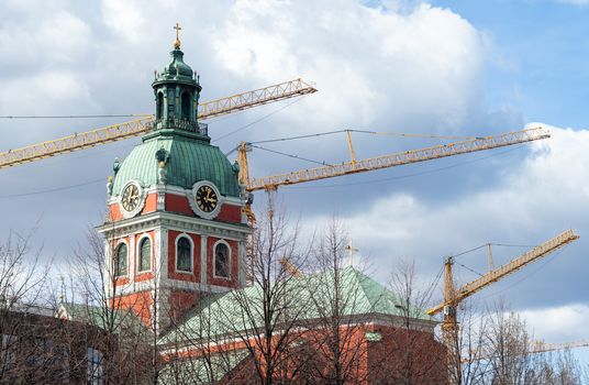 Construction cranes over the red Saint JamesÕs Church (Jakobs kyrka) in Stockholm.
