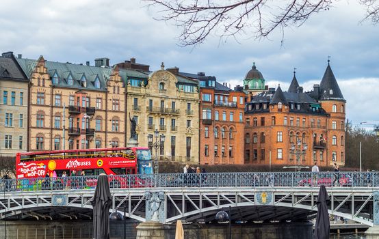 April 22, 2018 Stockholm, Sweden. Red sightseeing bus on the bridge Djurgardsbronin Stockholm.