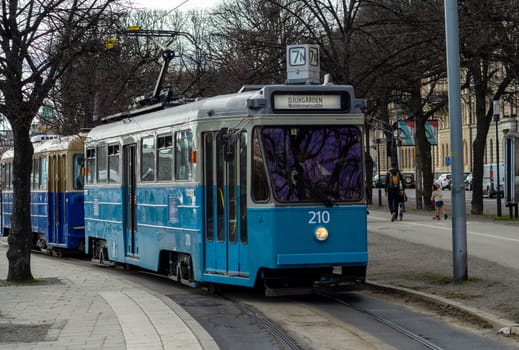 April 22, 2018, Stockholm, Sweden. Blue tram on one of the streets of Stockholm in spring clear weather.