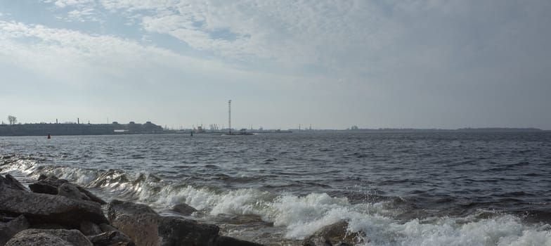 Waves break on the stone shore of the Gulf of Tallinn