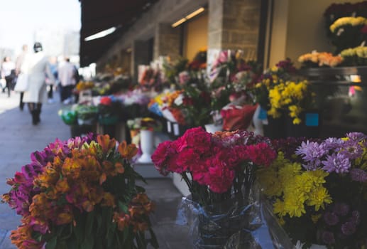 Multicolored bouquets of flowers in the window of a flower shop