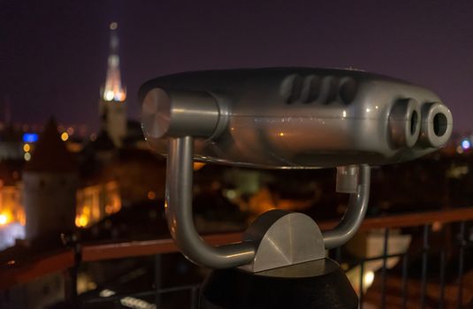 tourist binoscope on the observation deck in Tallinn at night