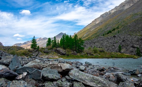 Mountain lake on the background of snow-capped peaks in the Altai Republic.