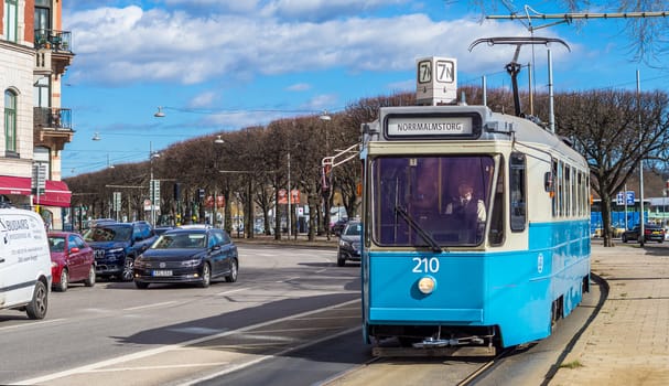 April 22, 2018, Stockholm, Sweden. Blue tram on one of the streets of Stockholm in spring clear weather.