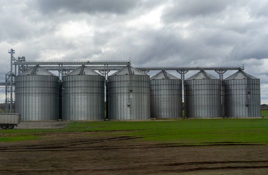 A modern granary in a field in a suburb of Vilnius in early spring.