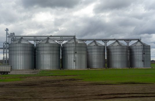 A modern granary in a field in a suburb of Vilnius in early spring.