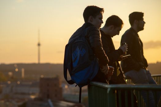 April 27, 2018 Vilnius, Lithuania, Young people on the observation deck on the hill of three crosses in Vilnius at sunset.