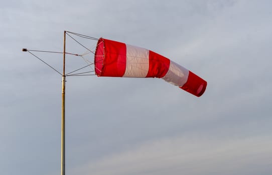 red-and-white wind designator designed to indicate the direction and approximate speed of the wind on the seashore