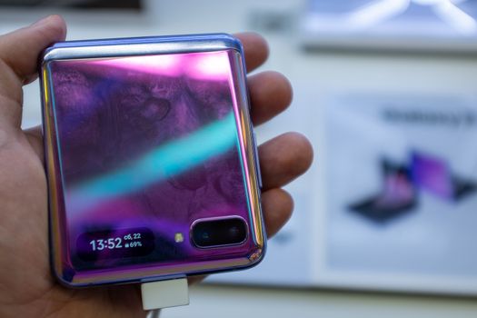 February 22, 2020, Moscow, Russia. New folding smartphone with a folding screen Samsung Galaxy Z Flip on the store counter.
