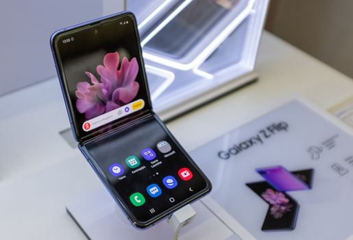 February 22, 2020, Moscow, Russia. New folding smartphone with a folding screen Samsung Galaxy Z Flip on the store counter.