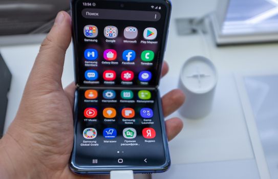 February 22, 2020, Moscow, Russia. New folding smartphone with a folding screen Samsung Galaxy Z Flip on the store counter.