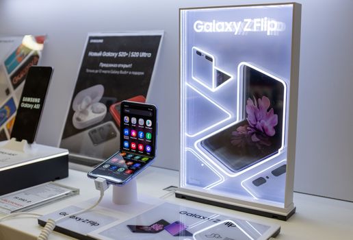 February 22, 2020, Moscow, Russia. New folding smartphone with a folding screen Samsung Galaxy Z Flip on the store counter.