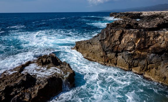 Waves crash on the rocky shore of the Mediterranean Sea on the Akamas Peninsula in the northwest of the island of Cyprus.