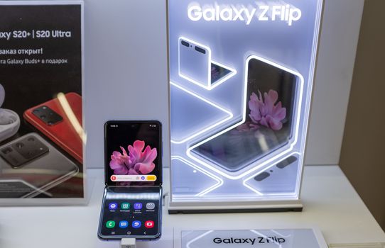 February 22, 2020, Moscow, Russia. New folding smartphone with a folding screen Samsung Galaxy Z Flip on the store counter.