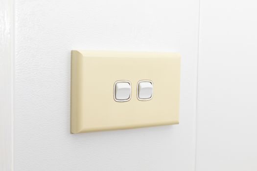A double light switch on a white tiled wall