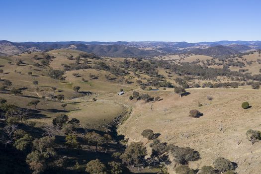 A dry creek bed running through farmland in regional Australia